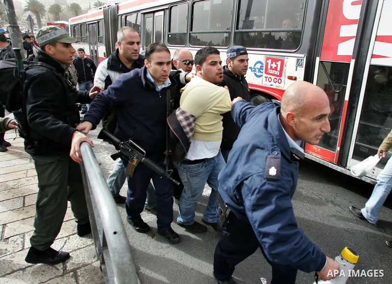 Israeli police officers detain a Palestinian protester in front of the Damascus Gate in Jerusalem's Old City December 17, 2009, after a march marking the last day of Jerusalem's tenure as the Arab League's "capital of Ar...
