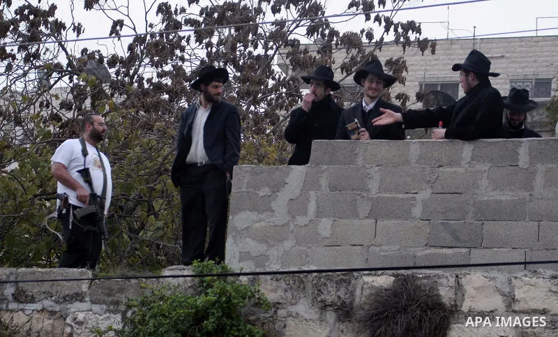 Tens of Israeli settlers and ultra-Orthodox Jews pay a visit to the Jewish shrine of Atnaeil Ben Kinaz in a Palestinian neighbourhood in the divided city of Hebron in the occupied West Bank to pray at the sacred tomb on...