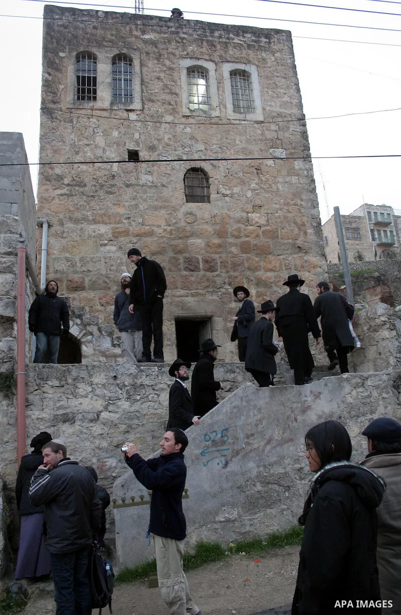 Tens of Israeli settlers and ultra-Orthodox Jews pay a visit to the Jewish shrine of Atnaeil Ben Kinaz in a Palestinian neighbourhood in the divided city of Hebron in the occupied West Bank to pray at the sacred tomb on...