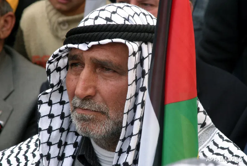 Palestinian Fatah supporters participate in a rally marking the movement's 45th anniversary in the West Bank city of Hebron on Jan 3, 2010 . Photo by Najeh Hashlamoun