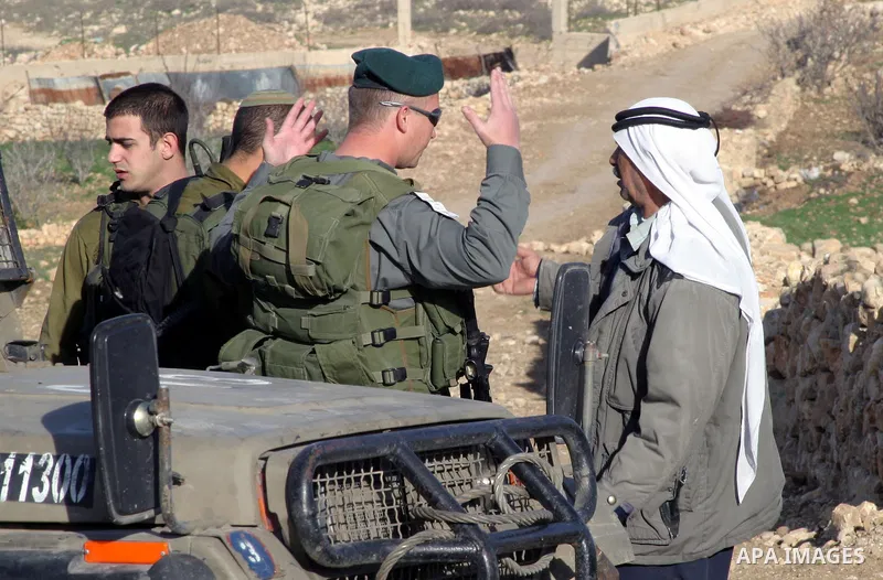 Israeli border policemen disperse Journalists, Palestinians and left-wing Israeli activists on January 11 2010. During a protest on agricultural land in the southern West Bank village of Safa, near Hebron. Photo by Najeh...