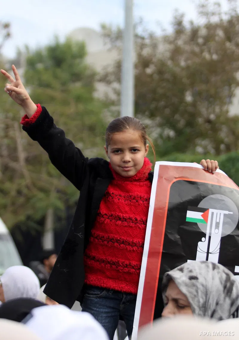 Palestinian child takes part in a protest outside the UN offices in Gaza City on January 14, 2010, during a protest against the Israeli blockade and in the occasion of the first anniversary of the massive Israeli militar...