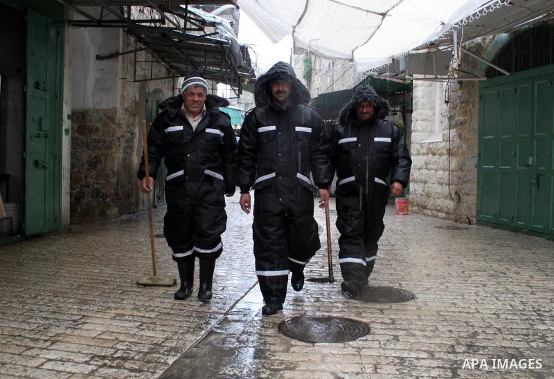 Palestinian workers from the municipality of Hebron checking the functioning of water in the market in the old city of West Bank city of Hebron, January 25, 2010. Photo by Najeh Hashlamoun