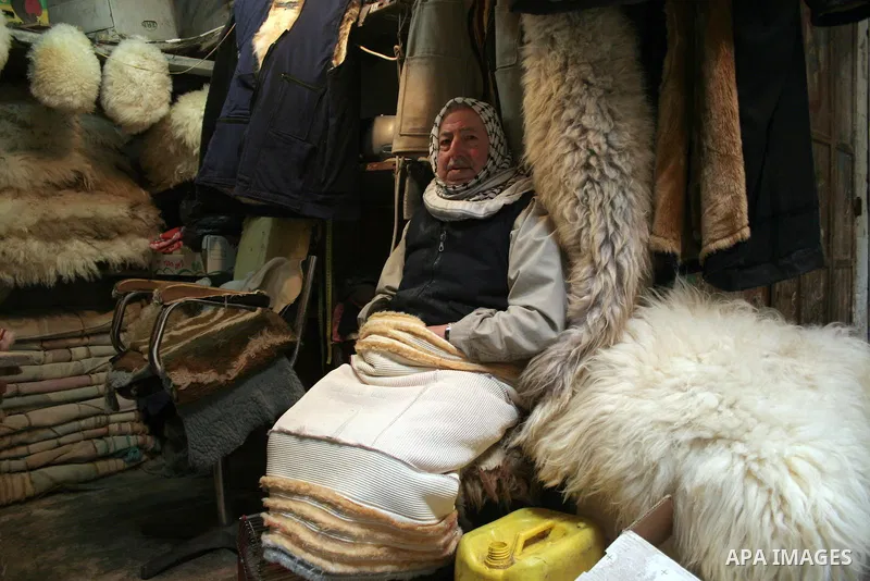 A Palestinian man sits in his shop in the market in the old city of West Bank city of Hebron January 25, 2010. Photo by Najeh Hashlamoun