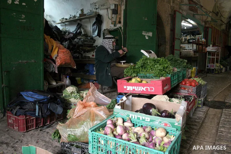 A Palestinian man sits in his shop in the market in the old city of West Bank city of Hebron January 25, 2010. Photo by Najeh Hashlamoun