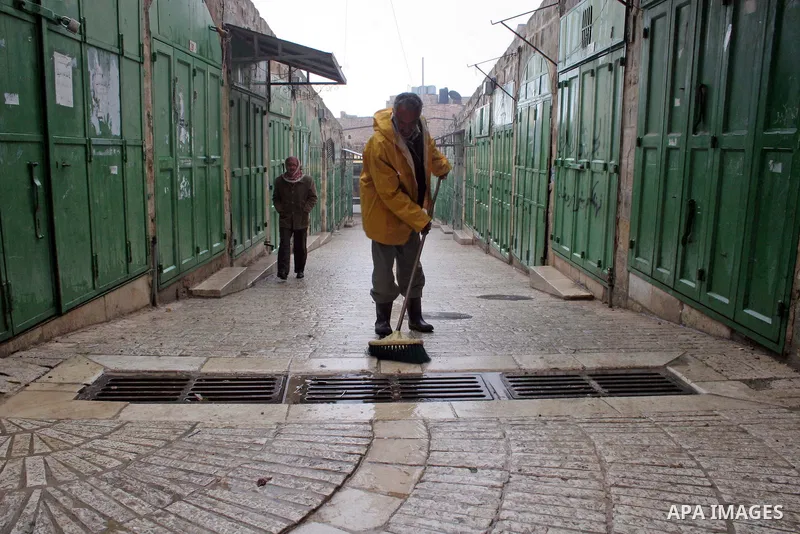 A Palestinian worker from Hebron Municipality checks the functioning of water in the market in the old city of West Bank city of Hebron, January 25, 2010. Photo by Najeh Hashlamoun