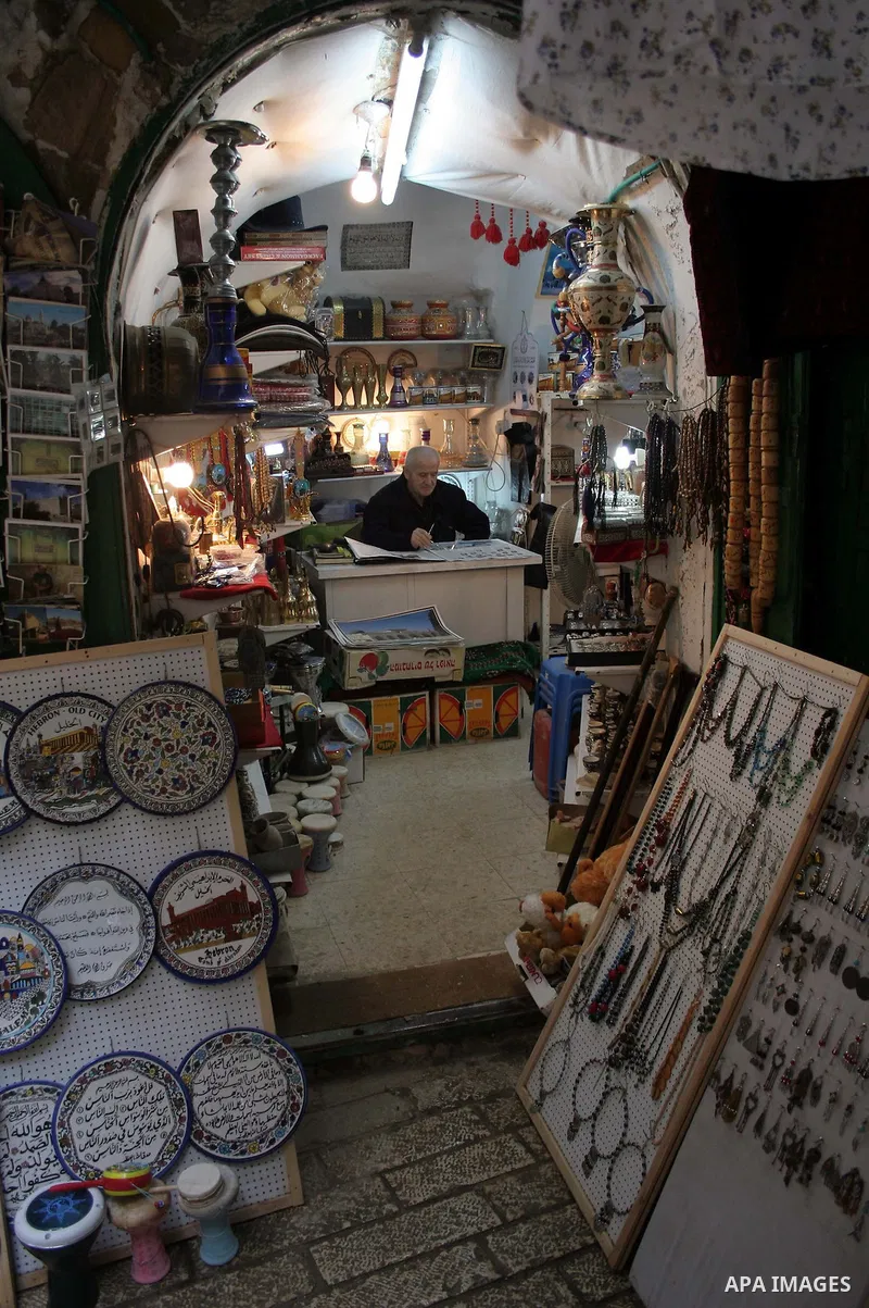 A Palestinian man sits in his shop in the market in the old city of West Bank city of Hebron January 25, 2010. Photo by Najeh Hashlamoun