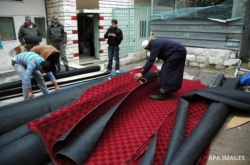 Palestinian policemen destroy an Israeli products in the West Bank city of Nablus on Jan 26,2010. Photo by Nedal Shtieh