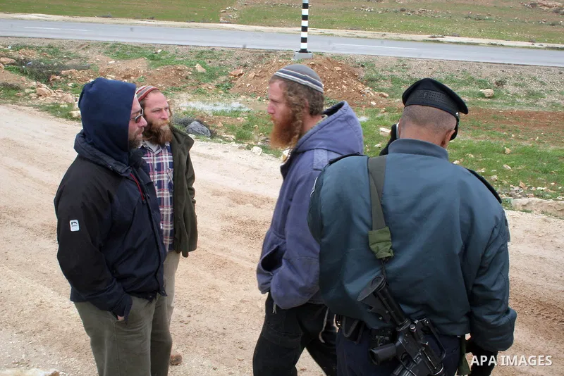 Israeli policemen stand guard after a confrontation between settlers with Palestinians in Twanie near the West Bank village of Yatta southern the West Bank city of Hebron January 26,2010. Photo by Najeh Hashlamoun