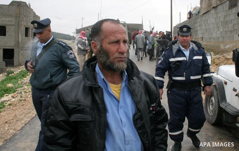 Israeli policemen stand guard after a confrontation between settlers with Palestinians in Twanie near the West Bank village of Yatta southern the West Bank city of Hebron January 26,2010. Photo by Najeh Hashlamoun