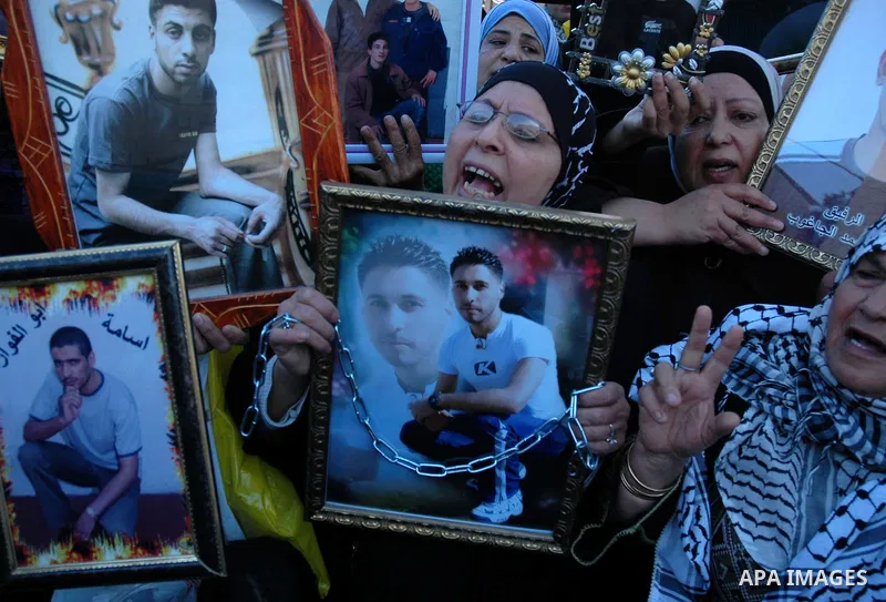 Palestinians take part in a protest calling for the release of prisoners from Israeli jails in the West Bank city of Nablus on January 27, 2010. At least 7500 Palestinians were being held in Israeli jails and detention f...