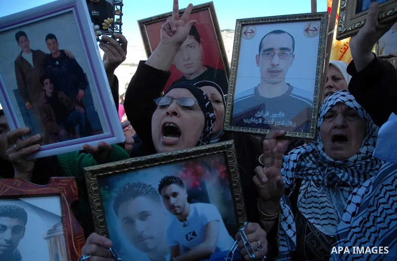 Palestinians take part in a protest calling for the release of prisoners from Israeli jails in the West Bank city of Nablus on January 27, 2010. At least 7500 Palestinians were being held in Israeli jails and detention f...