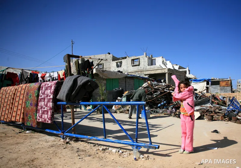 A Palestinian girl stands in front of a house destroyed during Israel?s 22-days military assault over Gaza in January 2009 at the in Jabalia refugee camp on January 29, 2010. Israel denied committing war crimes in a resp...