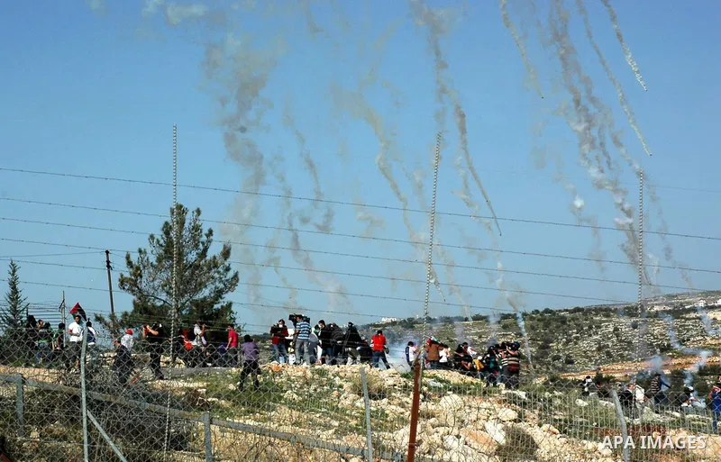Palestinian demonstrators demolish the wall during a demonstration on the sixth anniversary of the construction of the wall in Bil'in village in the West Bank city of Ramallah November 19, 2010. Photo by Nedal Shtieh