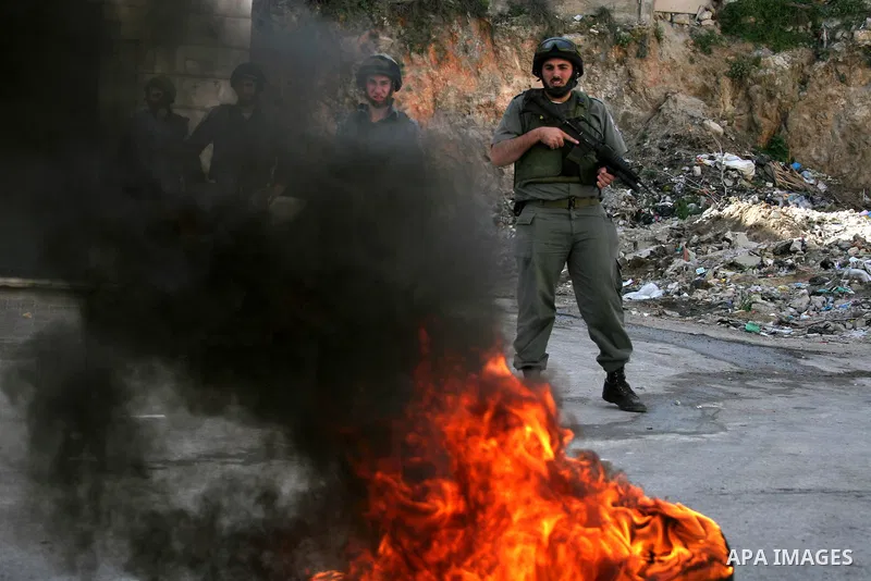 Israeli soldiers take position during clashes with the Palestinian in the West Bank city of Hebron on February 23, 2010. , after Israel's Prime Minister Benjamin Netanyahu was quoted in a statement as saying that the Tom...