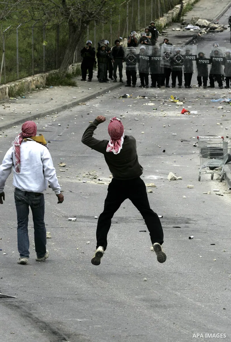 Masked Palestinian youths throw stones at Israeli soldiers during clashes in east Jerusalem on March 16, 2010. Hundreds of Palestinians clashed with Israeli security forces across east Jerusalem and the West Bank in the...