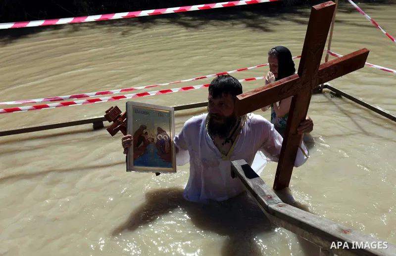 Orthodox Christians immerse themselves in the Jordan River at a baptism ceremony, during Holy Week, at Qasr el Yahud near the West Bank city of Jericho on March 31, 2010. The site is traditionally believed by many to be...