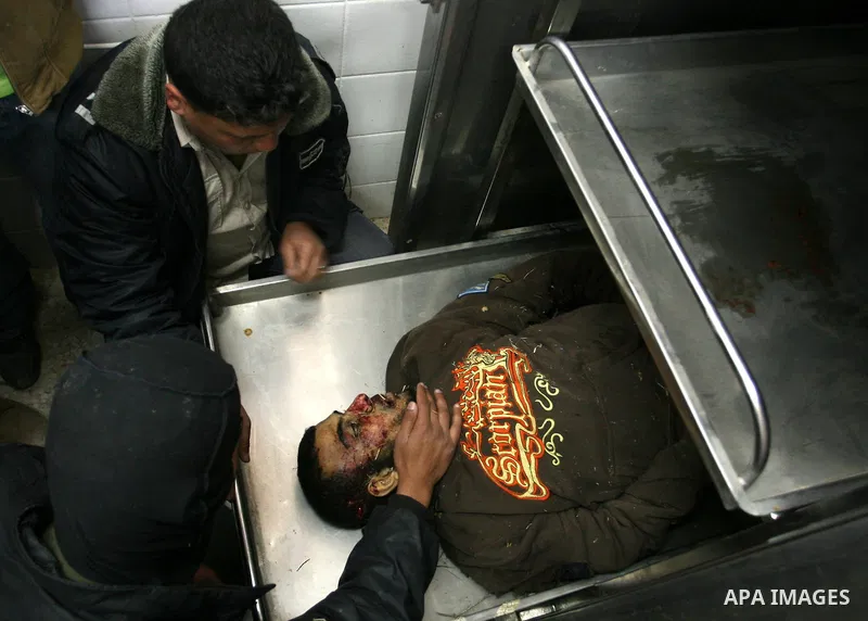 Relatives of Palestinian Islamic Jihad militant Marwan al-Jarba, 25, mourn over his body at the mortuary of Al-Aqsa hospital in Deir al-Balah, central Gaza Strip, on April 13, 2010. At least one Palestinian was killed an...