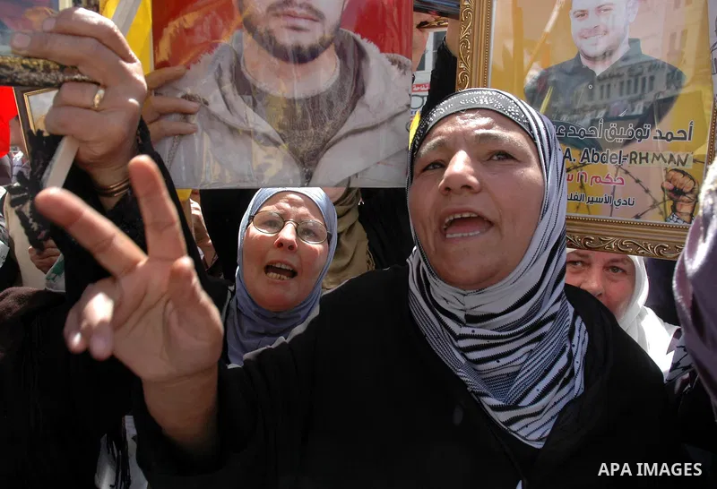 Palestinians hold pictures of their jailed relatives during a protest in the West Bank city of Nablus April 15, 2010, calling for the release of Palestinian prisoners from Israeli jails. Palestinians mark Palestinian Pri...