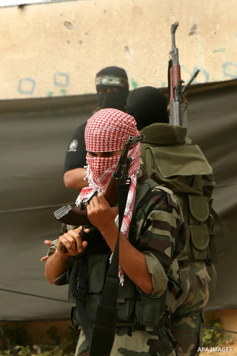 A militant with the Ezzedine Al-Qassam Brigades, the armed wing of the Islamist movement Hamas, take part in activities marking Prisoner Day in the Jabalia refugee camp, northern Gaza Strip, on April 16, 2010. More than...
