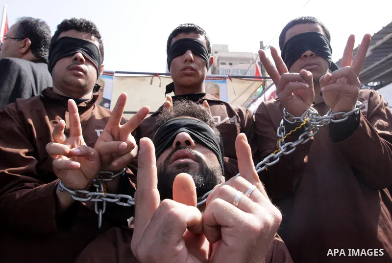 Palestinians take part during a protest on Prisoner Day in Gaza City on April 17, 2010. More than 7,000 Palestinians, including 270 who are under the age of 18, are currently held in Israeli prisons, the Palestinian Cent...