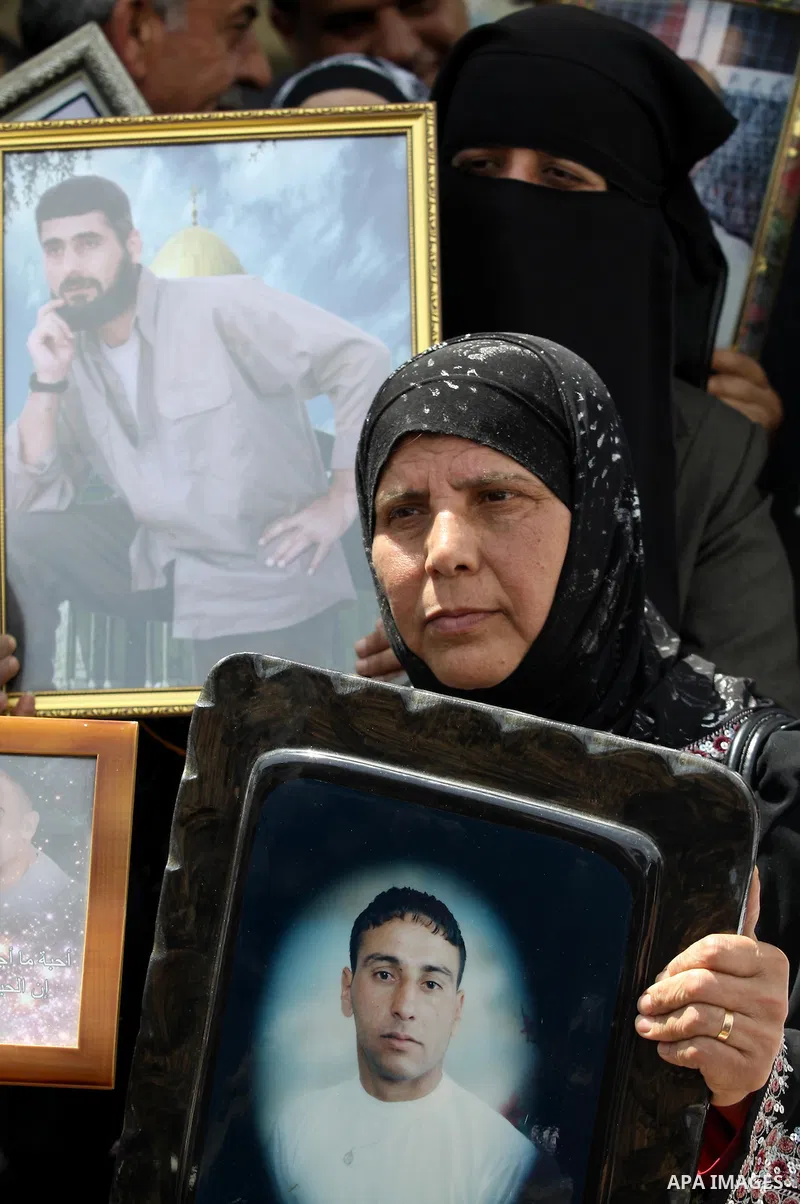 Palestinians hold pictures of their relatives, imprisoned in Israeli jails, during a demonstration calling for their release in the West Bank town of Jenin, Sunday, April 18, 2010. The demonstrators call for the release...