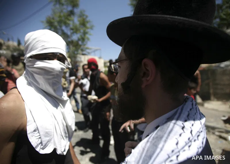 A member of Neturei Karta, a fringe of ultra-Orthodox movement within the anti-Zionist bloc in Israel, join Palestinians in a protest in the Arab east Jerusalem neighbourhood of Silwan on April 25, 2010. Palestinian prot...