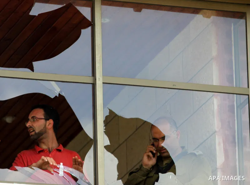 An Israeli soldier inspects a broken window, after Jewish settlers marched through the West Bank village of Hawara in a show of anger over what they said was a police campaign against them, Thursday, April 29, 2010. Ultr...