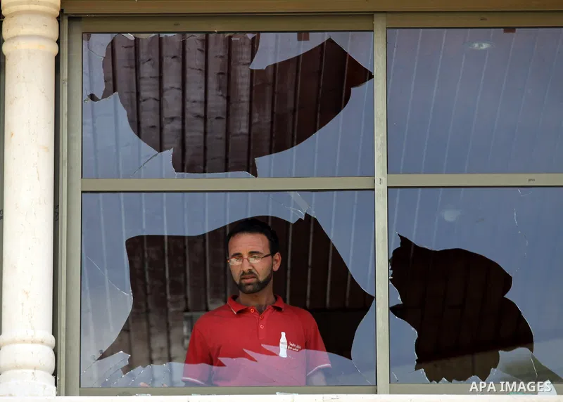 A Palestinian youth inspects a broken window, after Jewish settlers marched through the West Bank village of Hawara in a show of anger over what they said was a police campaign against them, Thursday, April 29, 2010. Ult...