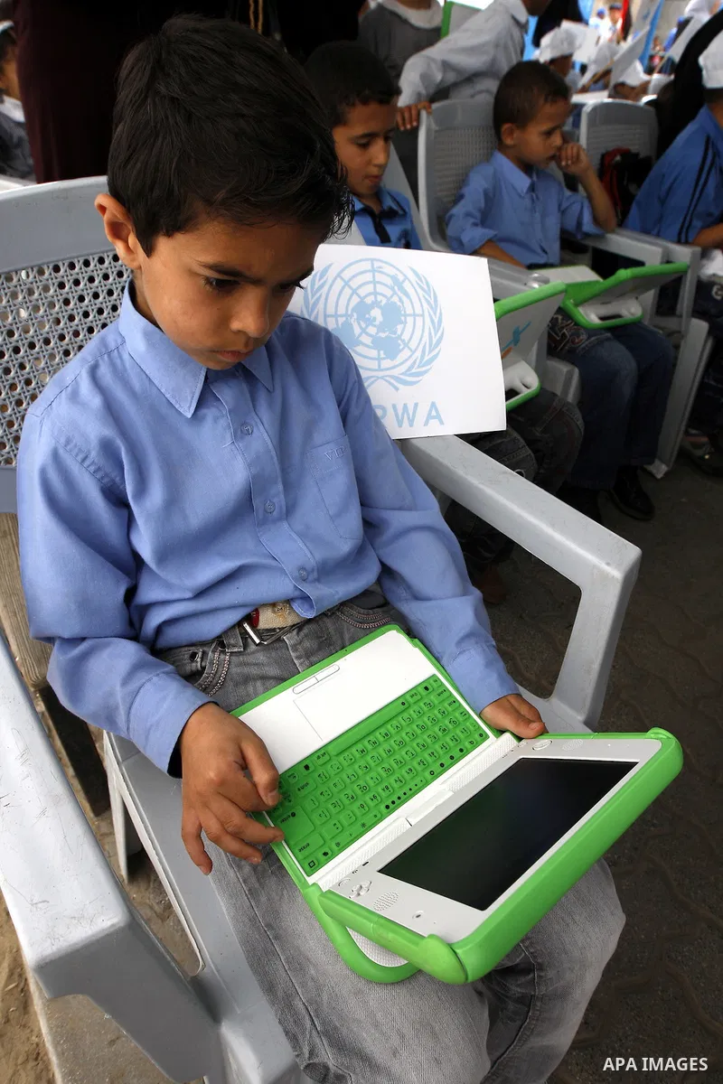 Palestinian students use new laptops at a United Nations school in Rafah refugee camp in the southern Gaza Strip on April 29, 2010. The United Nations Relief and Works Agency (UNRWA) launched a campaign to distribute som...