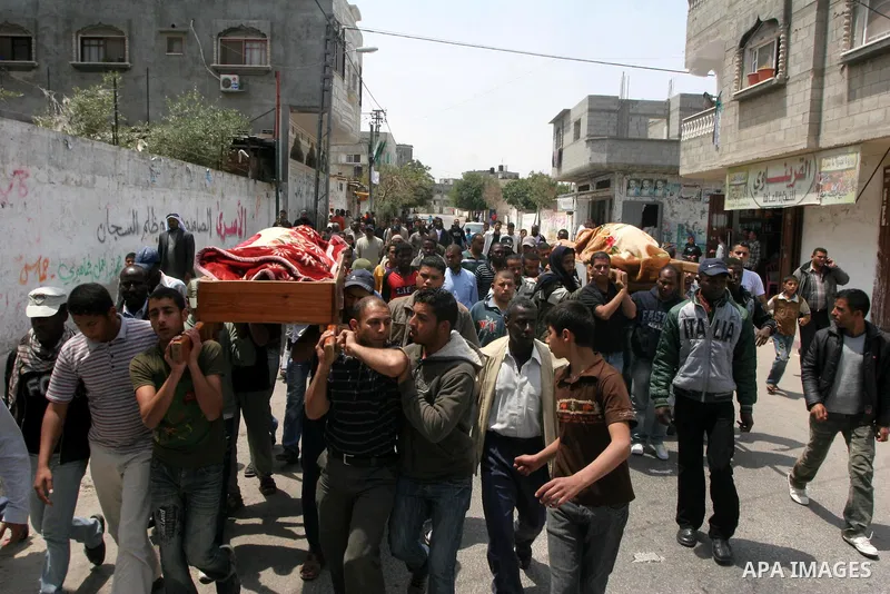 Palestinian mourners carry the bodies of smuggling-tunnel workers Muhammad Ali Abu Jamous, 25, and his brother Osama Abu Jamous, 20, during their funeral in Bureij refugee camp, central Gaza Strip, Thursday, April 29, 20...