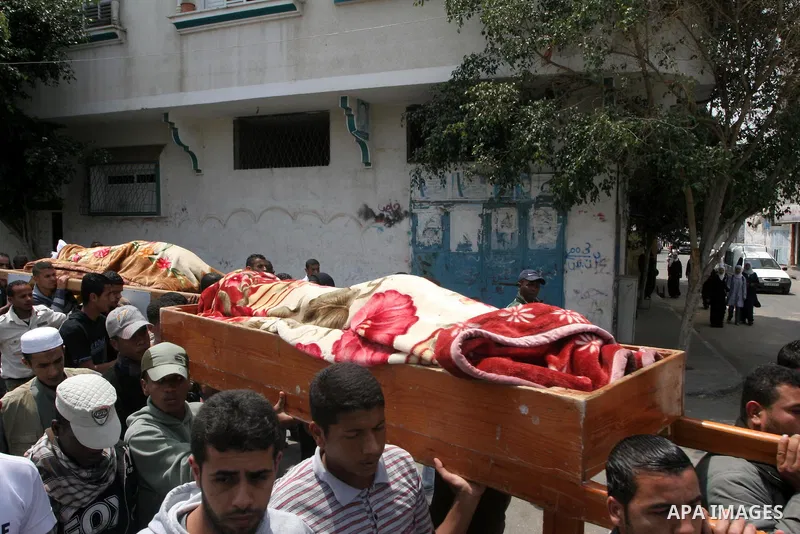 Palestinian mourners carry the bodies of smuggling-tunnel workers Muhammad Ali Abu Jamous, 25, and his brother Osama Abu Jamous, 20, during their funeral in Bureij refugee camp, central Gaza Strip, Thursday, April 29, 20...
