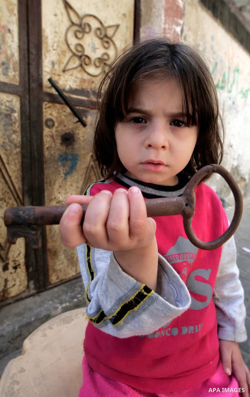 A Palestinian refugee girl from the Rafah refugee camp, holds up a key on May 08, 2010. in the Rafah refugee camp, southern Gaza strip. Palestinians are marking May 15, as Nakba Day or Catastrophe Day, as the 62nd annive...