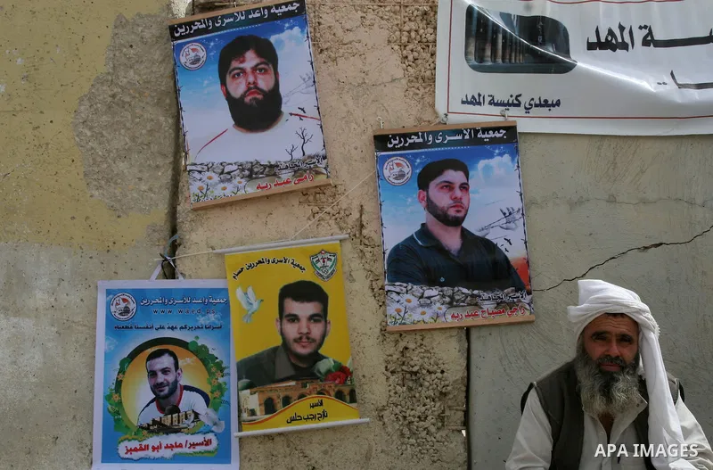 A Palestinian man attends a rally near the Erez crossing between Israel and the northern Gaza Strip on May 10, 2010, calling for the release of Palestinian prisoners from Israeli jails. As negotiators begin indirect talk...