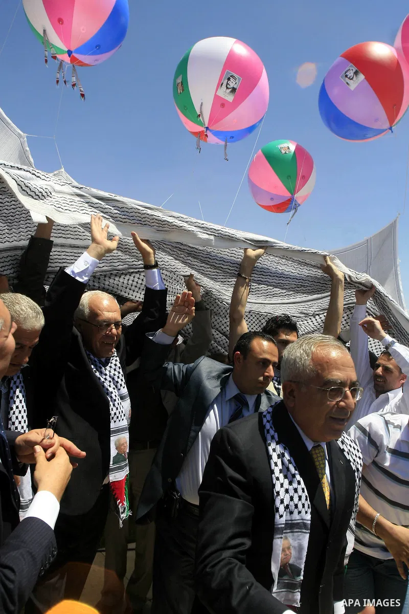 Palestinian Prime Minister, Salam Fayyad attends the launching ceremony of the largest Palestinian traditional scarf ''kefiya'' in the West Bank city of Ramallah, on May 13, 2010. The ceremony was held on Thursday in pre...