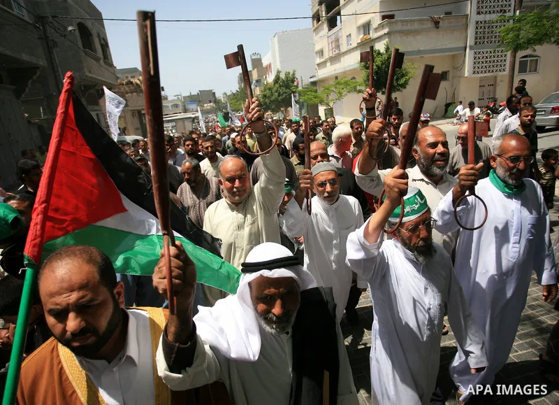 Palestinian men hold keys symbolizing the keys to houses left by Palestinians in 1948 during a rally marking the anniversary of the "Nakba", Arabic for catastrophe, in the Jabaliya refugee camp, northern Gaza Strip, Frid...