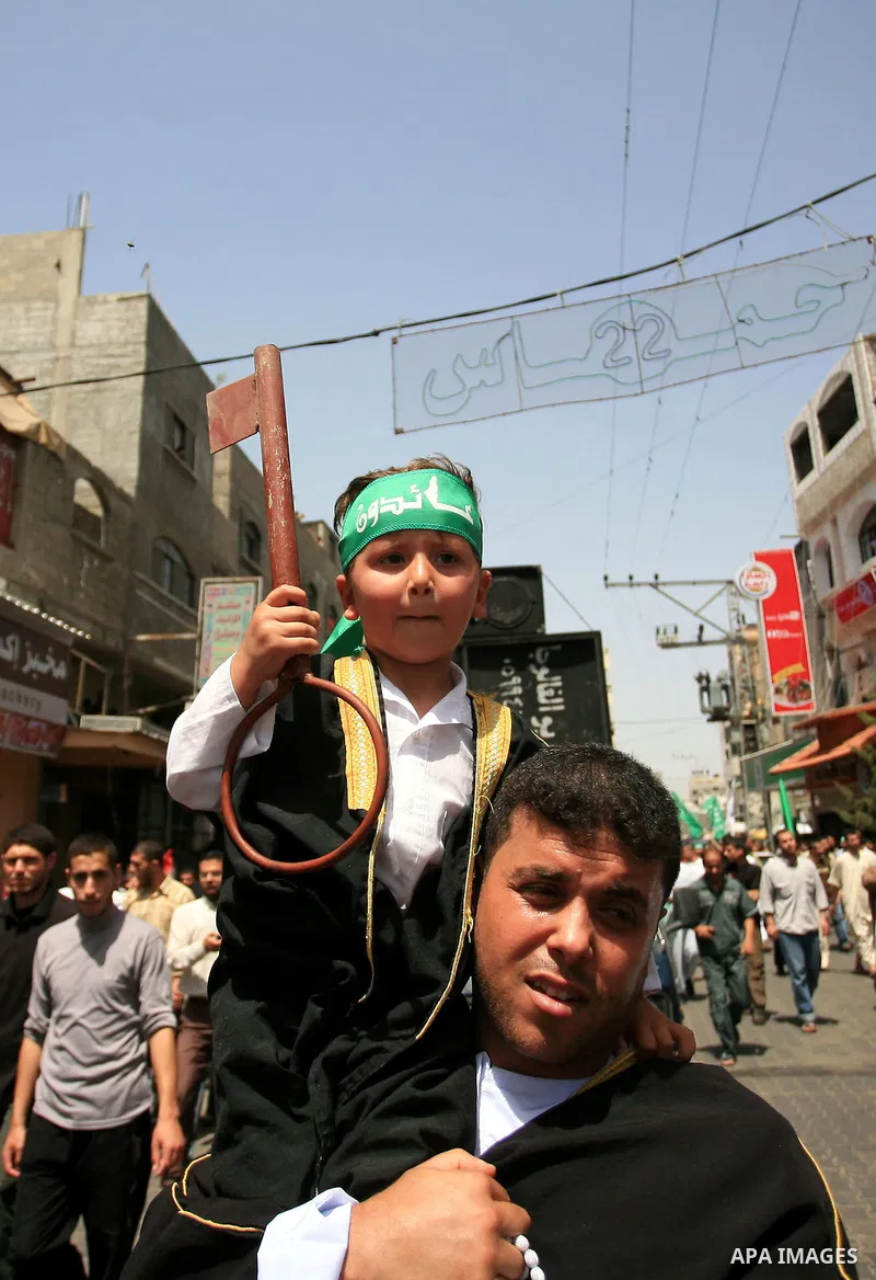 Palestinian boy holds a key symbolizing the keys to houses left by Palestinians in 1948 during a rally marking the anniversary of the "Nakba", Arabic for catastrophe, in the Jabaliya refugee camp, northern Gaza Strip, Fr...