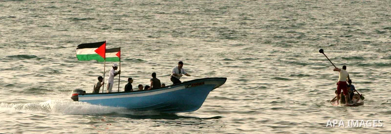 Palestinians ride boats at the beach of Gaza City May 14, 2010. Photo by Ali Jaad Allah.
