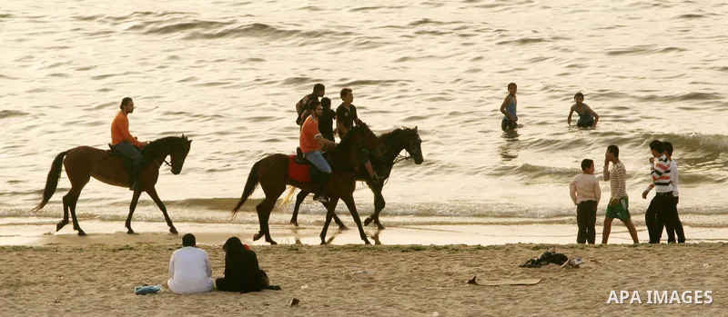 Palestinian youths ride their horses at the beach of Gaza City May 14, 2010. Photo by Ali Jaad Allah.