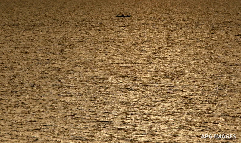 Palestinian fishermen ride their boat near the beach of Gaza City May 14, 2010. Photo by Ali Jaad Allah.