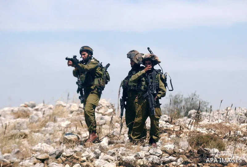 Israeli soldiers fire tear gas canisters towards Palestinian protesters during a demonstration against the expansion of Jewish settlements in the West Bank village of Iraq Burin, south of Nablus, on May 15, 2010 as Pales...