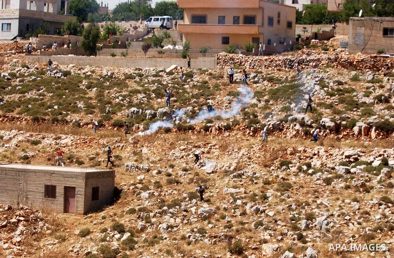 Palestinian protesters clash with Israeli soldiers during a demonstration against the expansion of Jewish settlements in the West Bank village of Iraq Burin, south of Nablus, on May 15, 2010 as Palestinians marked 62 yea...
