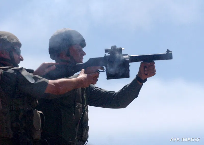 Israeli soldiers fire tear gas canisters towards Palestinian protesters during a demonstration against the expansion of Jewish settlements in the West Bank village of Iraq Burin, south of Nablus, on May 15, 2010 as Pales...