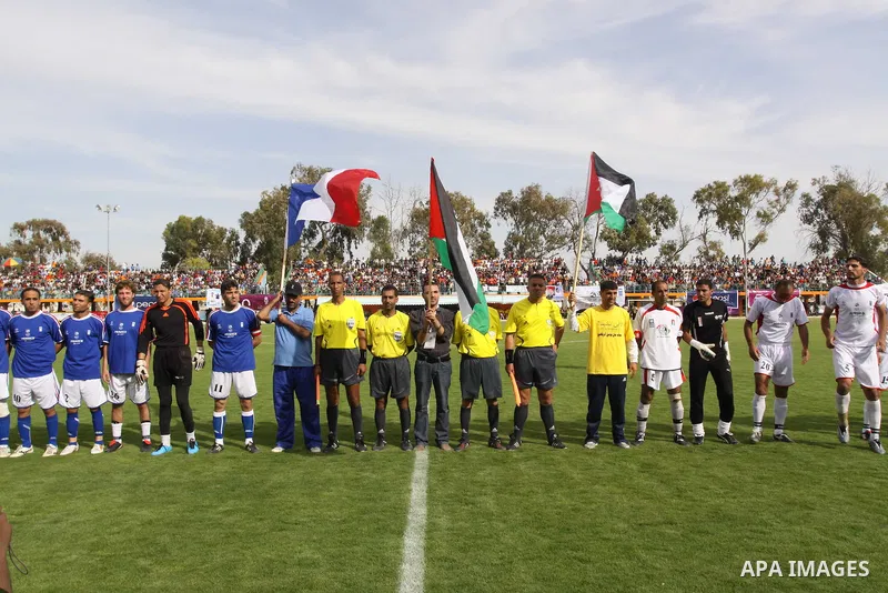 Palestinian players of Jordan, France and refrees take a picture before a soccer match during the final match of Gaza's version of the World Cup in Gaza City on May 15,2010. The Gaza Strip kicked off its own version of t...