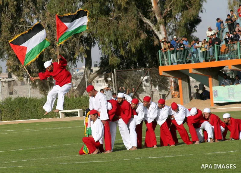 Palestinians take part in a celebration before a soccer match between France and Jordan during the final match of Gaza's version of the World Cup in Gaza City on May 15,2010. The Gaza Strip kicked off its own version of...