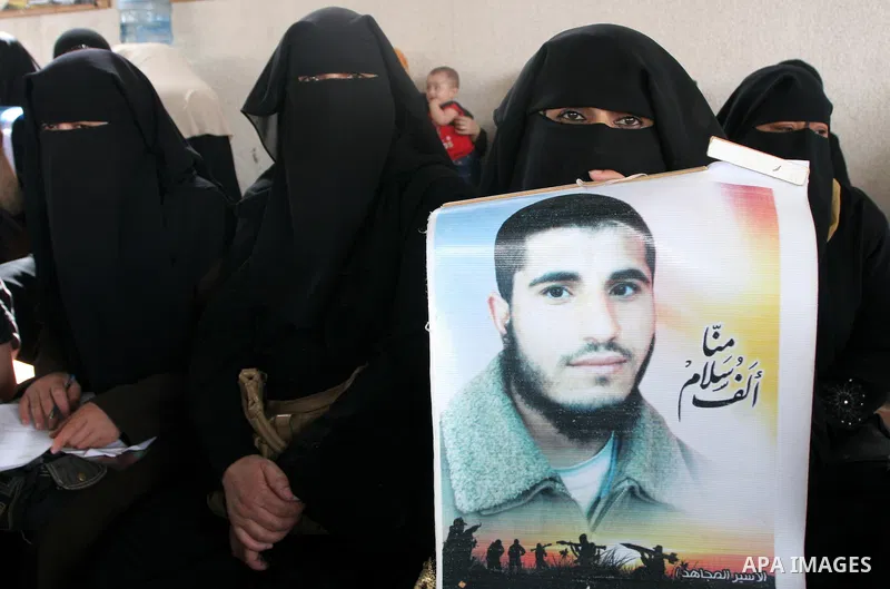 Palestinian women hold pictures of jailed relatives during a protest calling for the release of Palestinian prisoners from Israeli jails at the Red Cross office in Gaza City on May 17,2010. Photo by Ashraf Amra