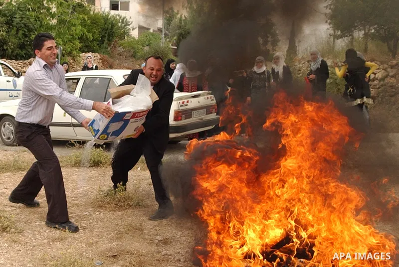 Palestinians burn the Jewish settlements products, in the west Bank city of Salfit on May 18, 2010. Photo by Wagdi Eshtayah