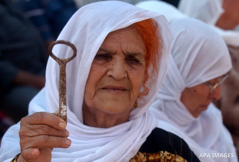 A Palestinian woman holds up a symbolic key during a rally marking the "Nakba" (Catastrophe) in the West Bank city of Salfit on May 19,2010. Photo by Wagdi Eshtayah