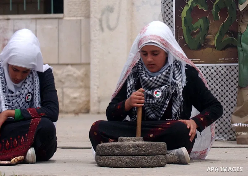 Palestinian girls wearing different traditional Palestinian take part in a rally marking the "Nakba" (Catastrophe) in the West Bank city of Salfit on May 19,2010. Photo by Wagdi Eshtayah