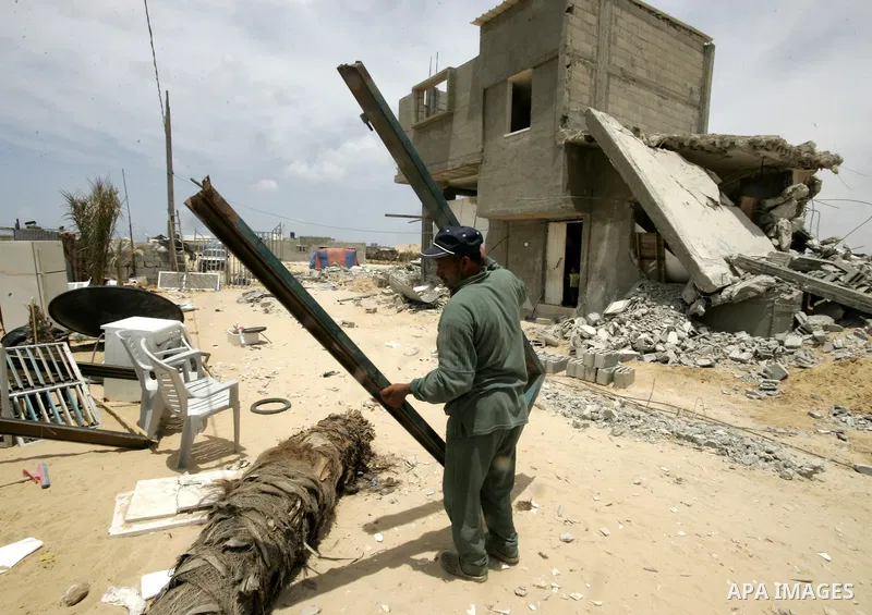 A Palestinian inspect his belongings after his house was demolished by Hamas security forces in Rafah in the southern Gaza Strip on May 19, 2010. Hamas Islamists ruling the Gaza Strip have been demolishing Palestinian ho...
